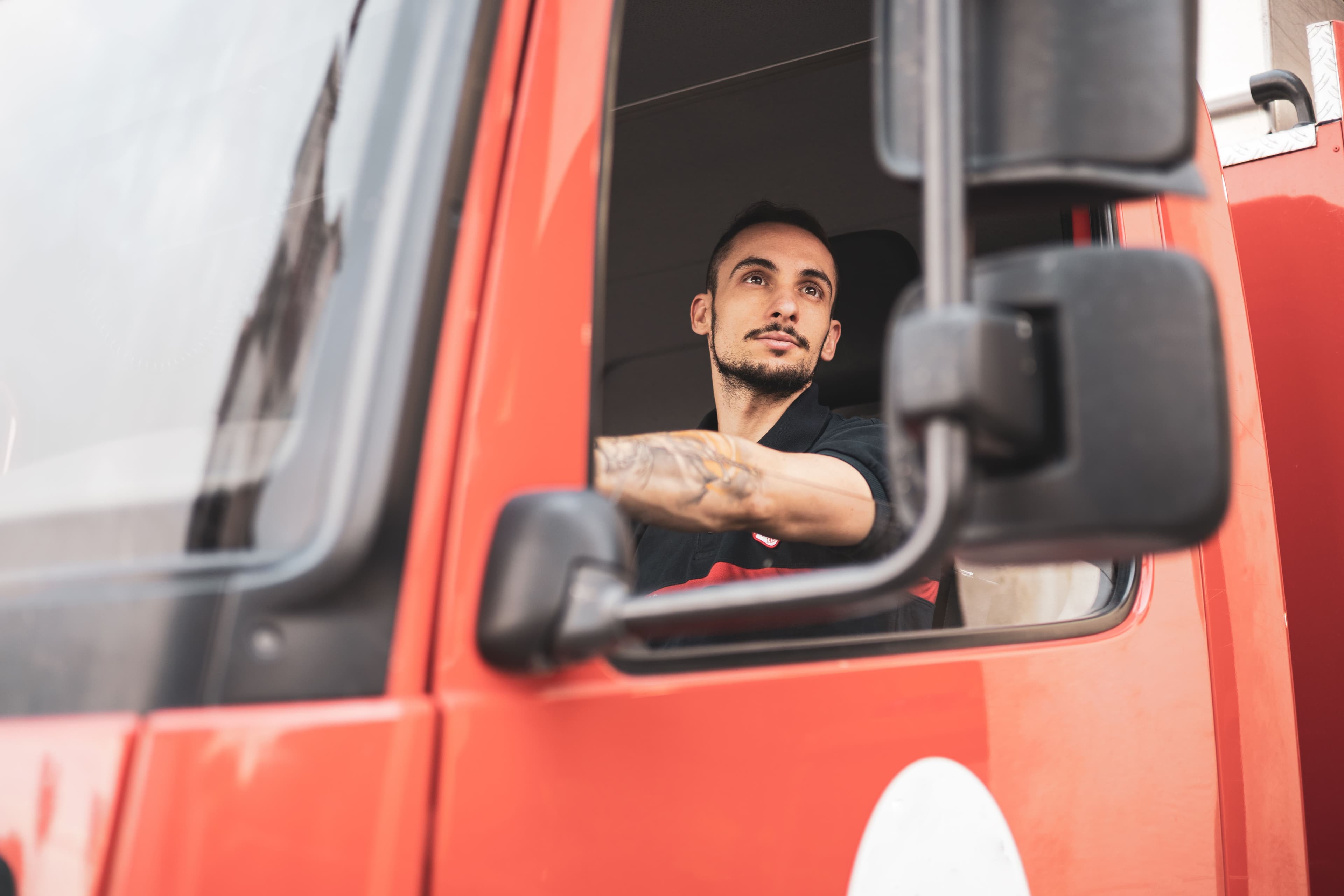 HGV driver looking at their side mirror