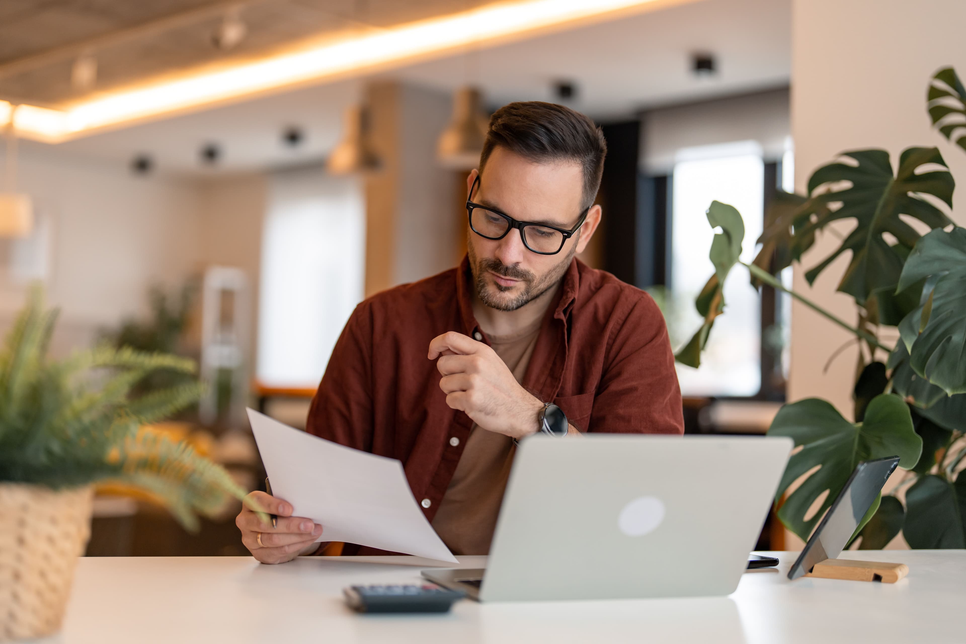 One person sat in a office looking over some paperwork