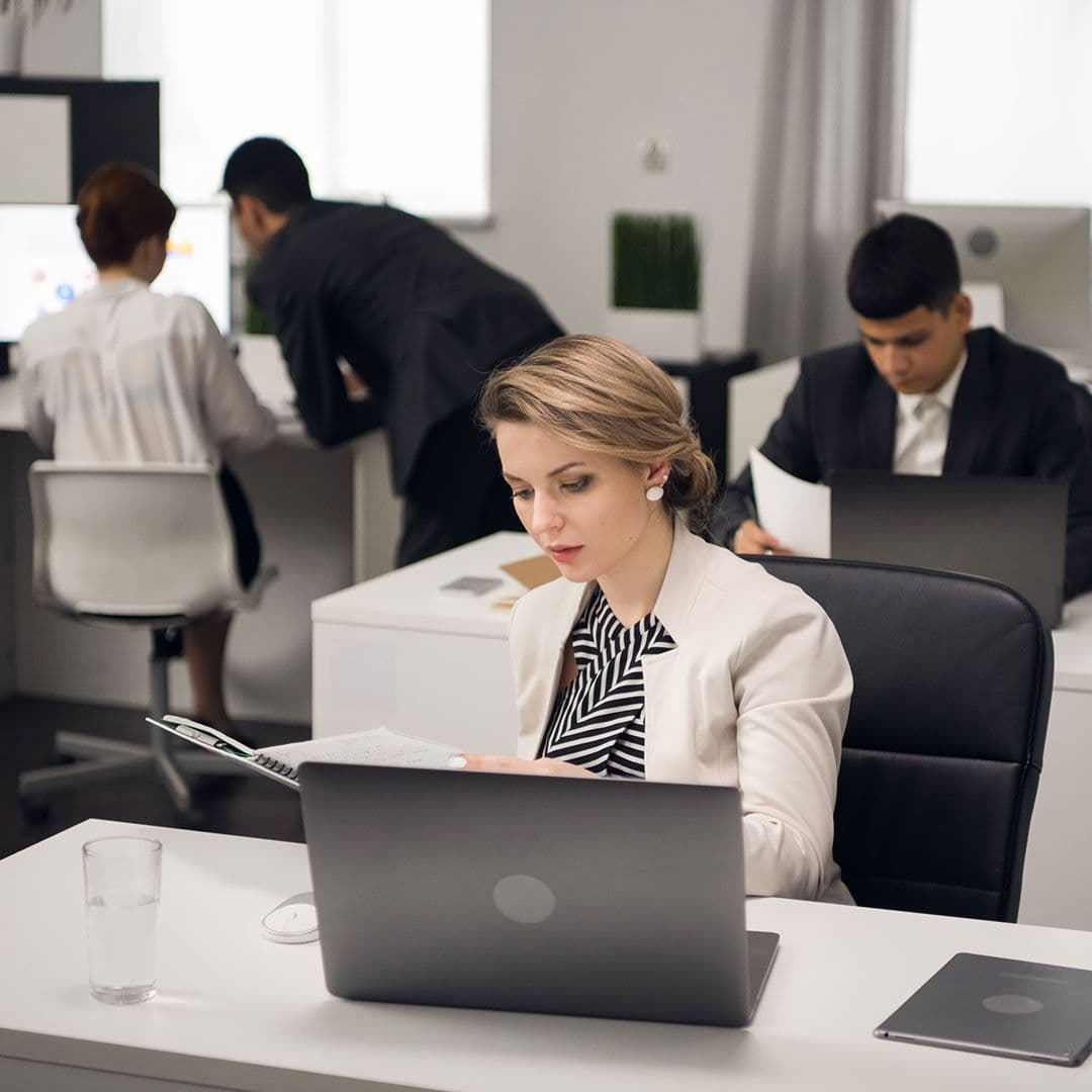 One person sat at their desk looking over paperwork