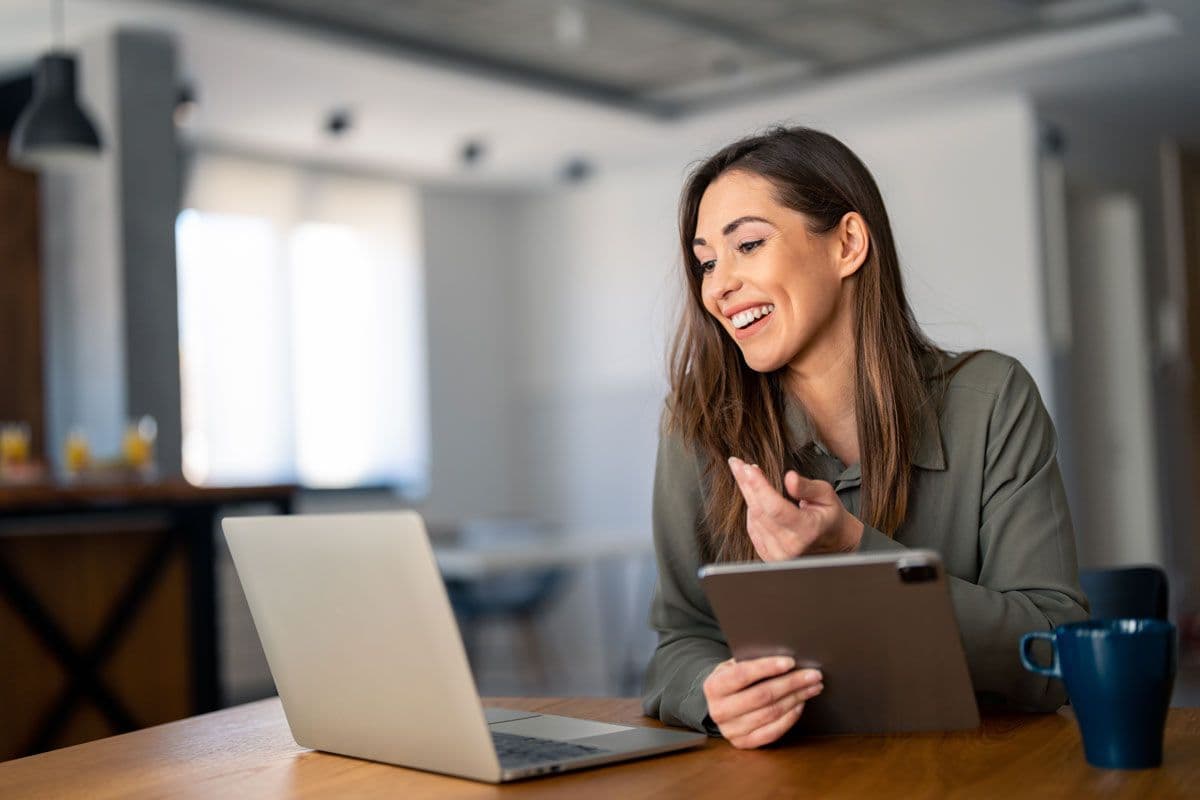 A person on a video call while holding their tablet