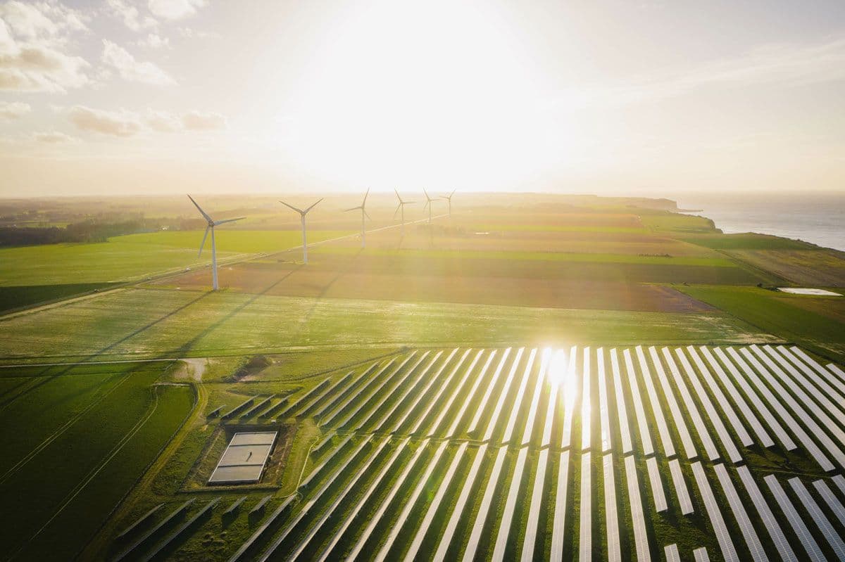 Aerial view of solar farm and wind turbines