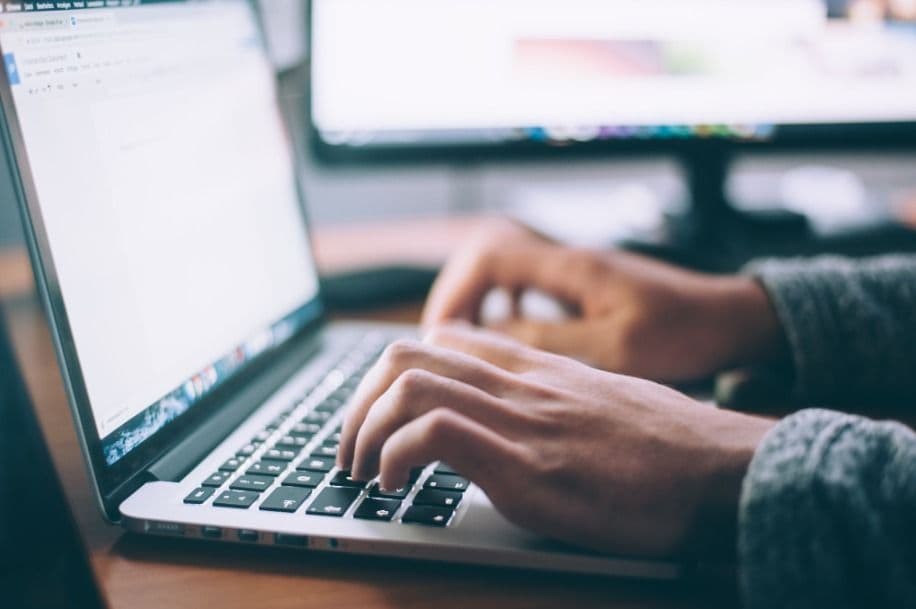 Someone typing on a laptop keyboard