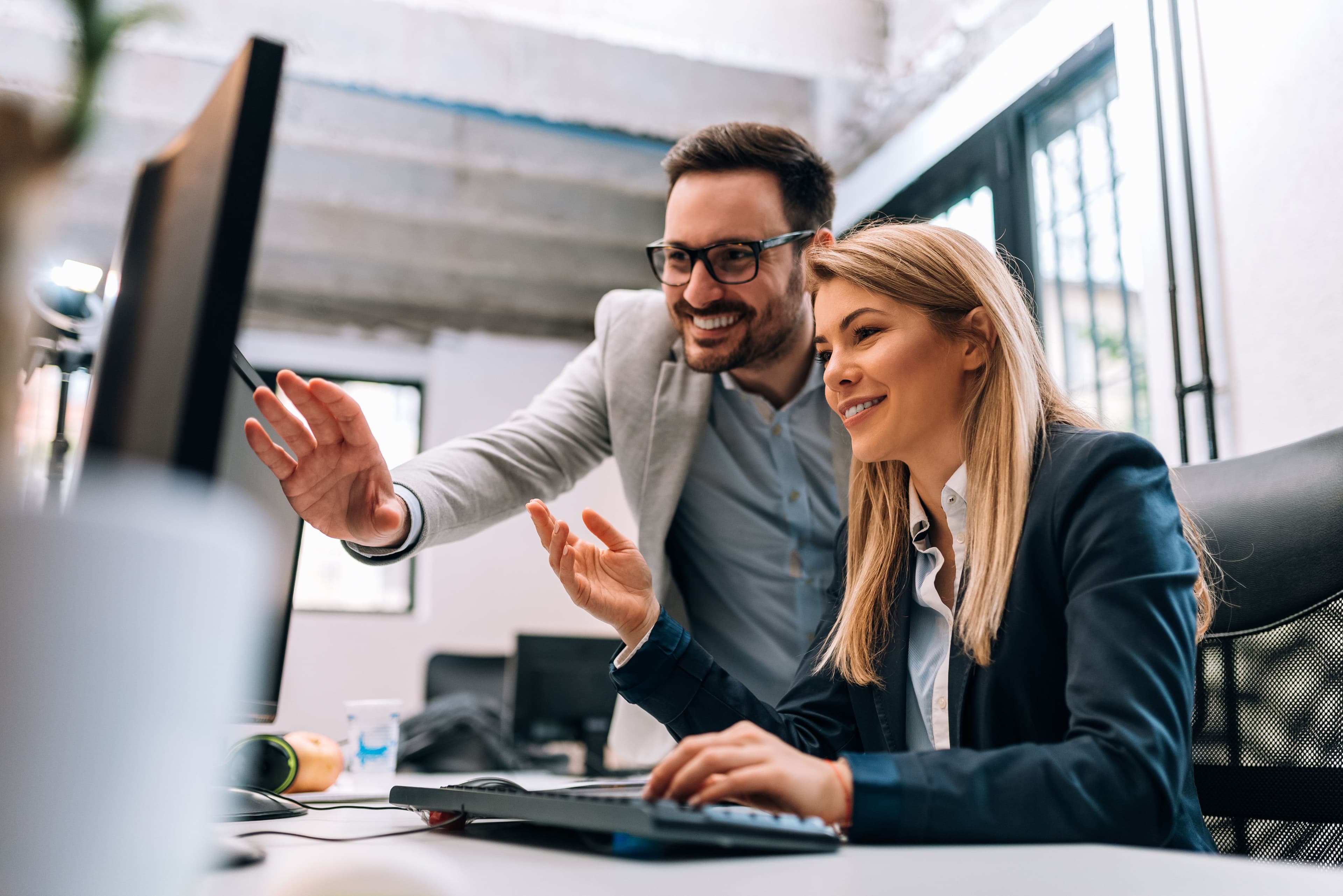 Two people using a computer having a business meeting