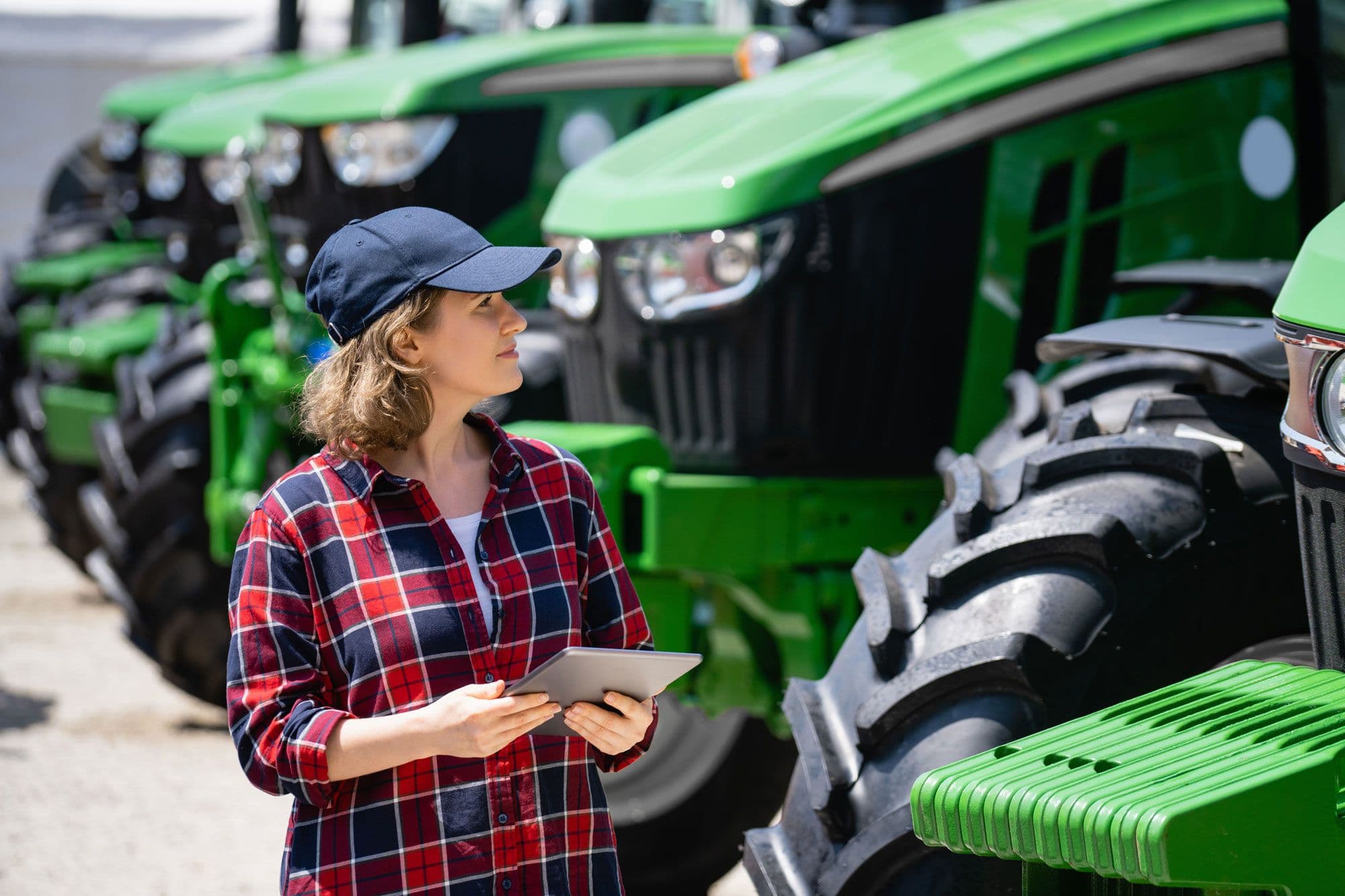 Someone looking at a green tractor