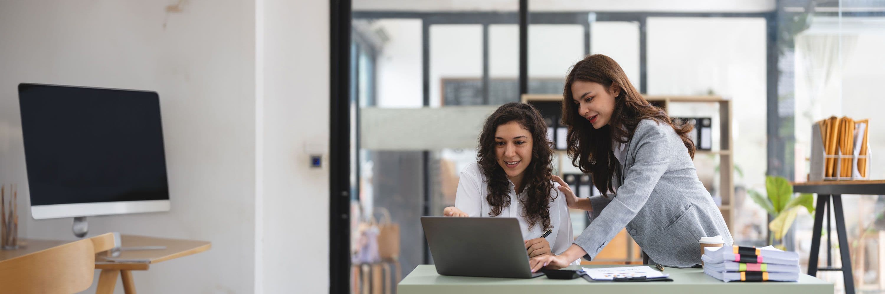 Two people working on a computer