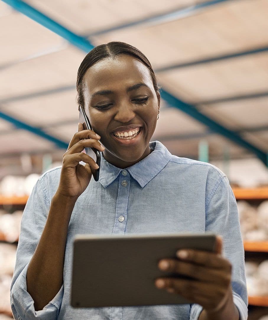 A person talking on the phone while holding a tablet